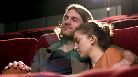 Couple-Sitting-In-The-Cinema-Watching-A-Movie-1