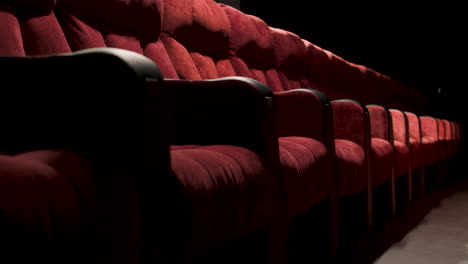 Side-View-Of-Red-Empty-Seats-In-The-Cinema