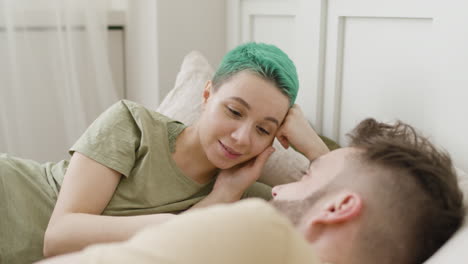 Loving-Couple-Looking-At-Each-Other-While-Relaxing-On-The-Bed-1