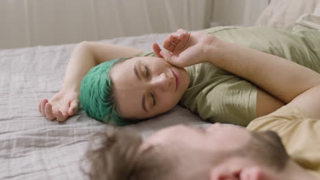 Man-Touching-His-Girlfriend's-Cheek-While-Lying-On-The-Bed-At-Home