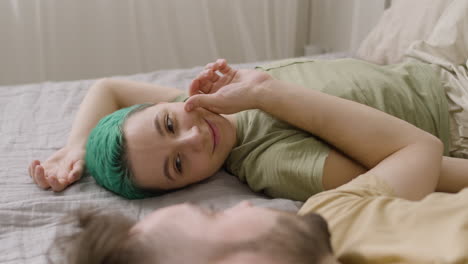 Man-Touching-His-Girlfriend's-Cheek-While-Lying-On-The-Bed-At-Home-1