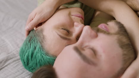 Close-Up-Of-A-Happy-Couple-Embracing-And-Cuddling-On-The-Bed-At-Home