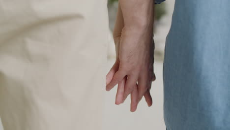Close-Up-Of-An-Unrecognizable-Couple-Standing-And-Holding-Hands-At-Home