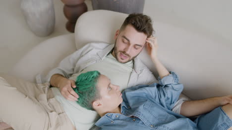Top-View-Of-Young-Couple-Sitting-On-Sofa,-Talking-And-Caressing-Each-Other-1