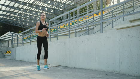 Young-Jogger-Woman-Running-In-The-Stadium-On-A-Summer-Morning