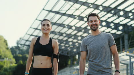 Young-Jogger-Couple-Giving-Five-To-Each-Other-And-Smiling-To-The-Camera-After-Running-Training-Time-1