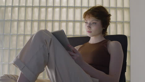 Bottom-View-Of-Tired-Girl-Sitting-On-A-Chair-Using-A-Tablet-1