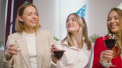 Happy-Multiethnic-Group-Of-Female-Colleagues-Toasting-With-Champagne-And-Wine-At-The-Office-Party