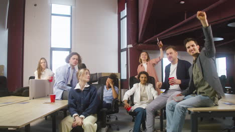 Group-Of-Multiethnic-Colleagues-Watching-A-Sportive-Match,-Cheering-And-Supporting-Their-Team-At-The-Office-3