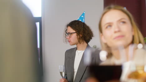 Happy-Young-Man-Drinking-Champagne-And-Talking-With-A-Colleague-At-The-Office-Party