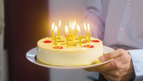 Close-Up-Of-Male-Hands-Holding-A-Piece-Of-A-Birthday-Cake-On-A-Plate