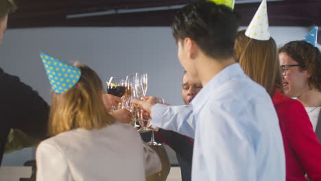 Happy-Multiethnic-Colleagues-Toasting-With-Champagne-And-Wine-And-Drinking-At-The-Office-Party-2