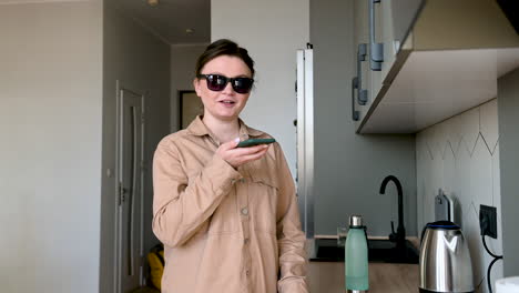 Happy-Blind-Woman-With-Glasses-Talking-On-Mobile-Phone-At-Home