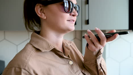 Smiling-Blind-Woman-With-Glasses-Talking-On-Mobile-Phone-At-Home