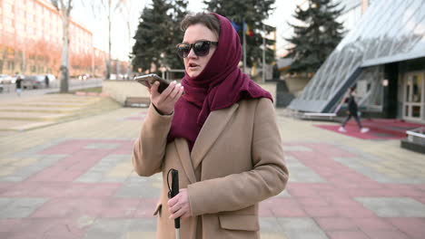 Blind-Woman-Talking-On-Mobile-Phone-Outdoors-On-A-Winter-Day