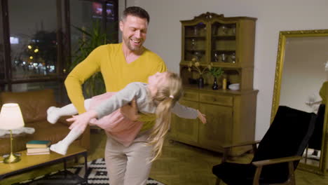 Father-And-Daughter-Playing-In-The-Living-Room-At-Home