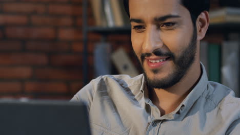 Arabian-Businessman-Watching-Something-On-The-Tablet-And-Smiling-In-The-Office