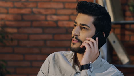 Close-Up-View-Arabian-Businessman-Speaking-On-The-Phone-In-The-Office