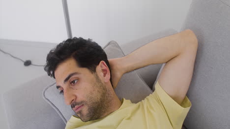 A-Good-Looking-Man-Is-Resting-On-A-Sofa