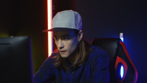 Close-Up-View-Of-Young-Man-Wearing-Cap-And-Playing-A-Game-On-The-Computer-And-Annoyed-By-Losing-1
