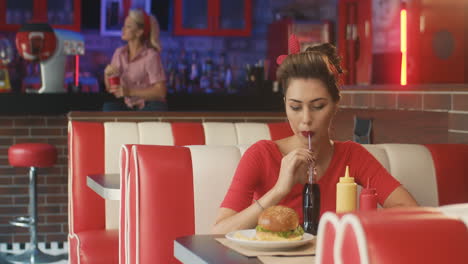 Pin-Up-Girl-Drinking-A-Coke-In-An-American-Diner