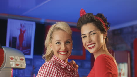 Cute-Pin-Ups-Blowing-Kisses-And-Smiling-In-An-American-Diner