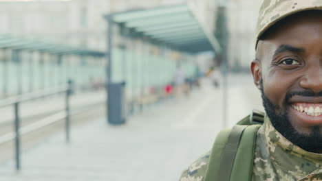 Portrait-Of-A-Cheerful-Soldier-Smiling-On-The-Bus-Stop