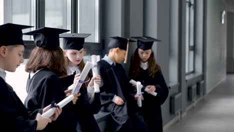 Group-Of-Happy--Preschool-Students-In-Mortarboard-And-Gown-1