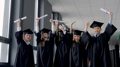 Group-Of-Happy--Preschool-Students-In-Mortarboard-And-Gown-6