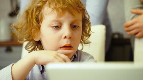 Blue-Eyed-Kid-Watching-Somehting-On-His-Tablet