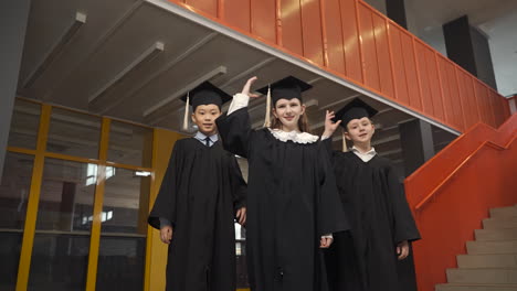 Happy--Students-Throwing-Their-Mortarboards-Up-In-The-Air