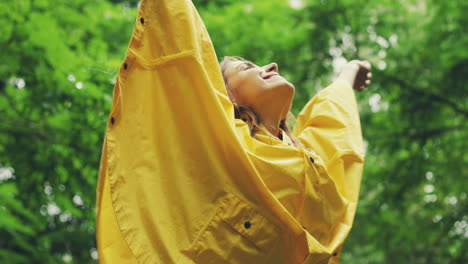 View-From-Below-Of-A-Happy-Girl-In-A-Yellow-Raincoat
