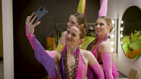 Three-Showgirls-Taking-A-Selfie-In-The-Backstage