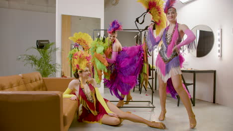 Three-Showgirls-Having-Fun-With-A-Feather-Fan