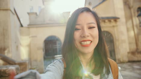 Pov-Of-The-Charming-And-Happy-Young-Woman-Talking-Cheerfully-To-The-Camera-Like-Having-Videochat-Outside-While-Doing-Sightseeing-In-The-Town