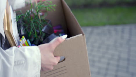 Close-Up-Of-Woman's-Hands-Carrying-Things-In-A-Box