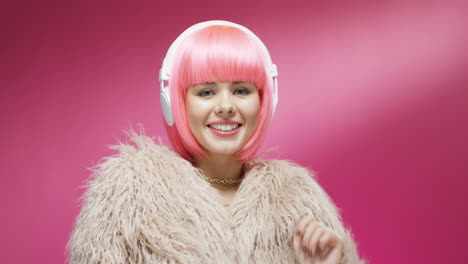 Close-Up-Of-Attractive-Woman-Wearing-A-Pink-Wig-And-Headphones-And-Dancing-Joyfully-1