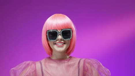Portrait-Of-Beautiful-Woman-Wearing-A-Pink-Wig-And-Glamorous-Glasses