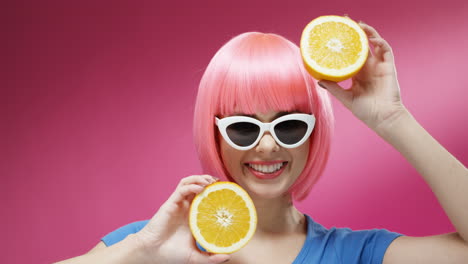 Close-Up-Of-Woman-Wearing-Sunglasses-And-A-Pink-Wig-Closing-Eyes