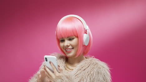 Portrait-Of-Pretty-Woman-Wearing-A-Pink-Wig-And-Headphones