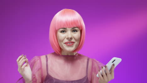 Close-Up-Of-Stylish-Woman-Wearing-A-Pink-Wig-Tapping-And-Texting-On-Mobile-Phone-And-Reading-Message