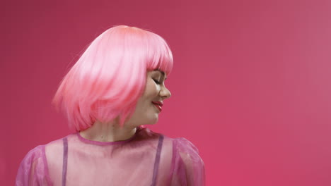 Portrait-Of-A-Beautiful-Woman-Wearing-A-Pink-Wig-Dancing-And-Laughing