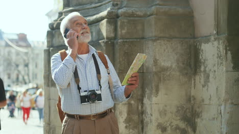 Senior-Tourist-With-Photocamera-And-Map
