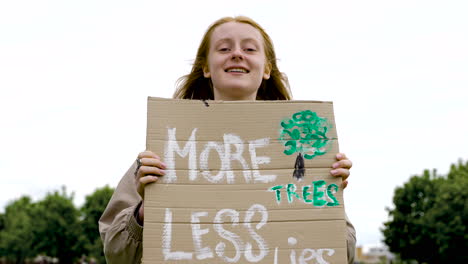 Close-Up-Of-A-Redhead-Woman-Holding-A-Placard-And-Talking