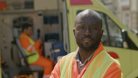Black-Male-Ambulance-Driver-With-Crossed-Arms-At-The-Street