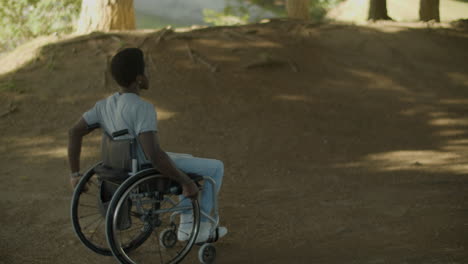 Junger-Schwarzer-Mann,-Der-An-Sommertagen-Mit-Seinem-Rollstuhl-Draußen-Fährt
