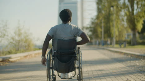 Back-View-Shot-Of-Black-Man-Riding-Wheelchair-Outside-1