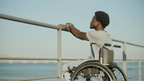 Young-Black-Man-In-Wheelchair-Enjoying-Sea-View
