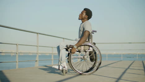 Happy-Black-Man-In-Wheelchair-Having-Fun-At-Seafront