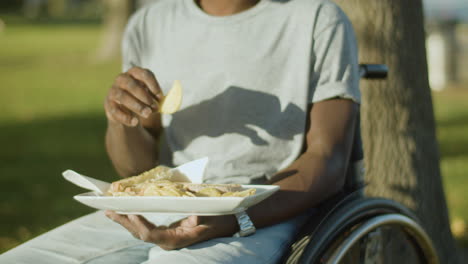 Closeup-Of-Black-Man-In-Wheelchair-Having-Lunch-In-City-Park